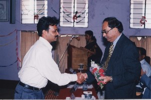 One of the students of the first batch of diploma course students felicitates Dr. A.M. Pathan, Vice Chancellor of Karnatak University, on the diploma course during the inauguration 