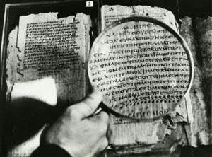 Leaves of Codex II: The leaves of Codex II lying (backwards) in the cover, open at pages 50-51, on the right page 50 (magnified by Pahor Labib), the conclusion and subscript title of the Gospel of Thomas, and on the left, lying on top of page 48 (visible at the right edge), and already conserved in glass, Codex I, page 50. Copyright Claremont Graduate University (Institute for Antiquity and Christianity, School of Religion)