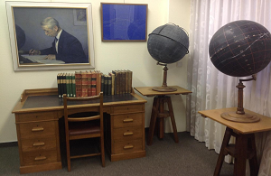 The Kapteyn Room at the Kapteyn Astronomical Institute. The picture shows in the back Kapteyn's desk (with a sample of his publications) and globes, the painting by Jan Veth, and a star map he made as a teenager.