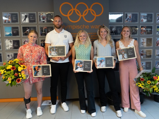 The athletes in front of the wall