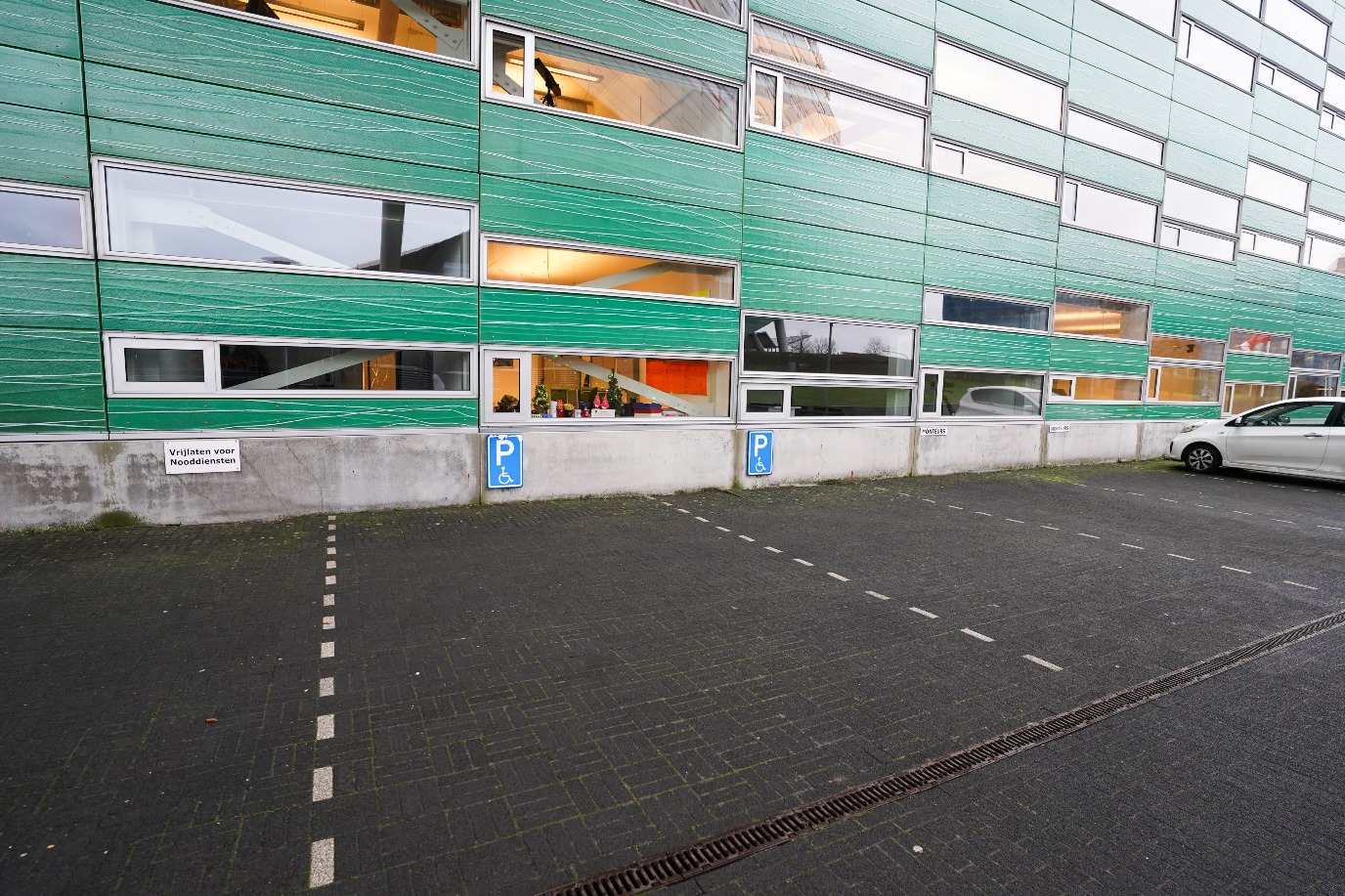 On-site parking for people with a disability, to the right of the main entrance