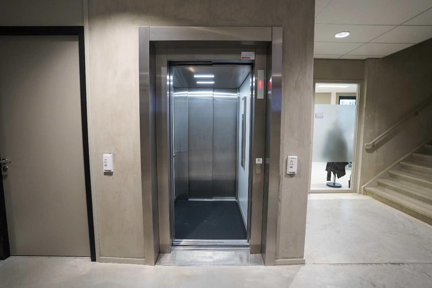 Elevator on site, from college entrance after reception to left