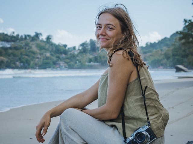 Denise at Las Cuevas, her favorite beach on Trinidad's north coast, taking photographs of the Trinidadian landscape as part of her project.