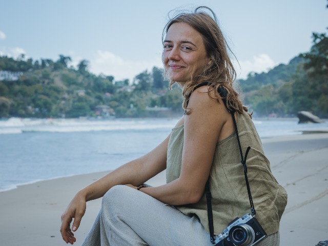 Denise at Las Cuevas, her favorite beach on Trinidad's north coast,&nbsp;taking photographs of the Trinidadian landscape as part of her project.