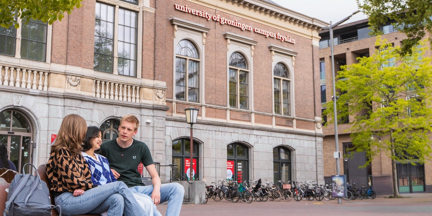 Studenten op een bankje voor de campus