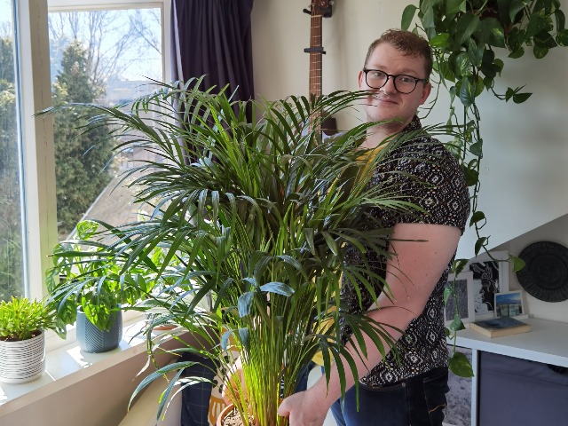 Proud plant papa with his plants