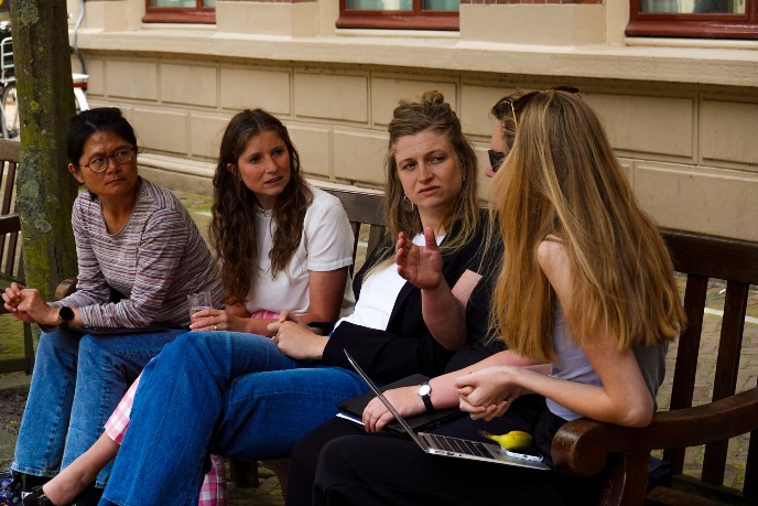 students talking on a bench