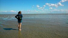 woman standing on shoreline