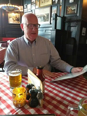 Henk Ritsema reading a menu