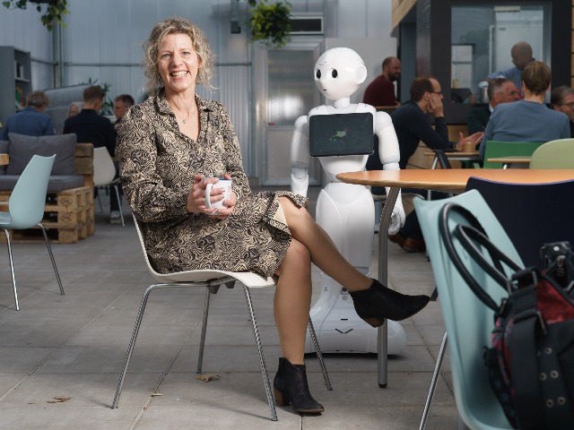 Professor Jenny van Doorn with social robot Pepper.