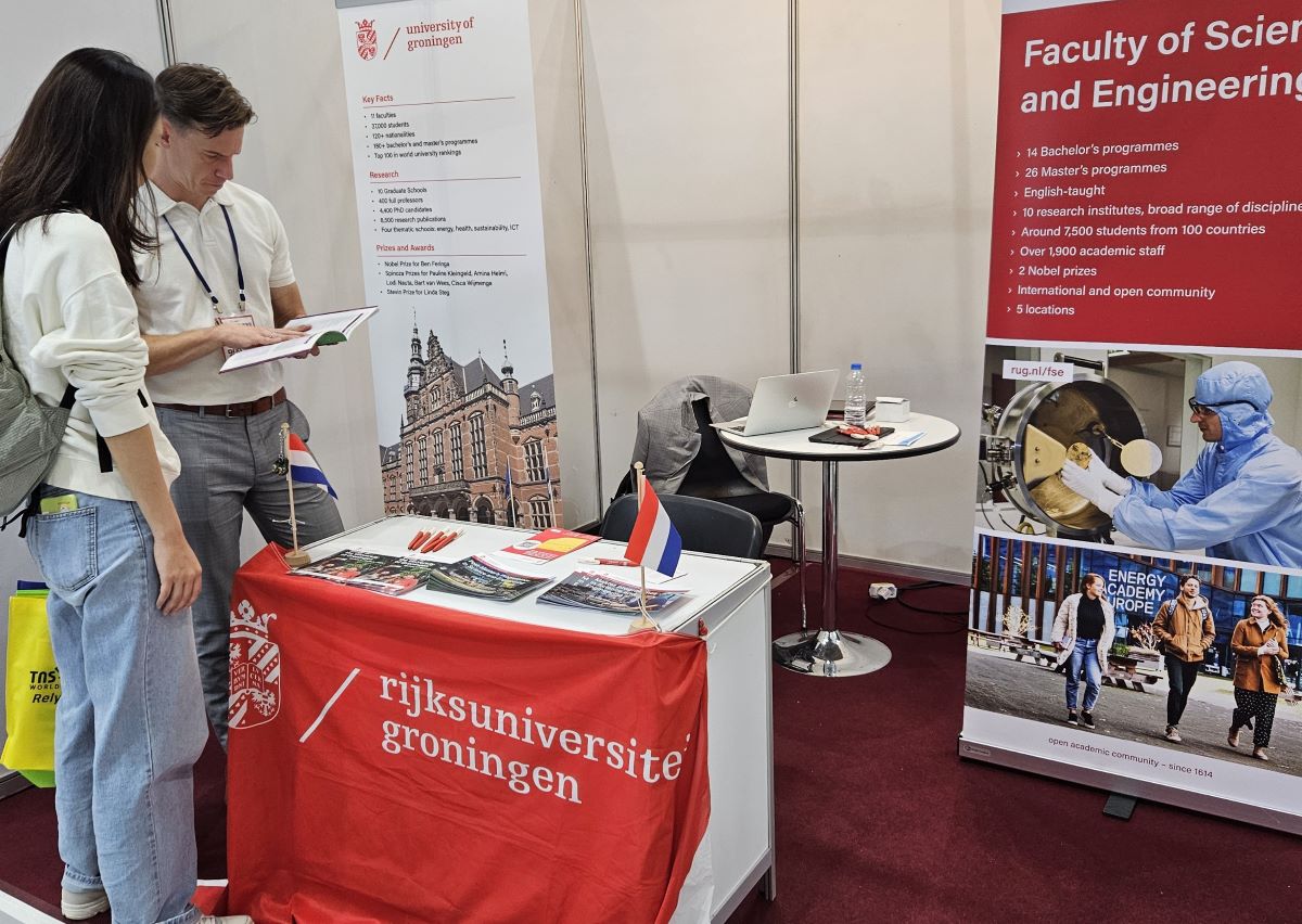 Student with ambassador at information fair