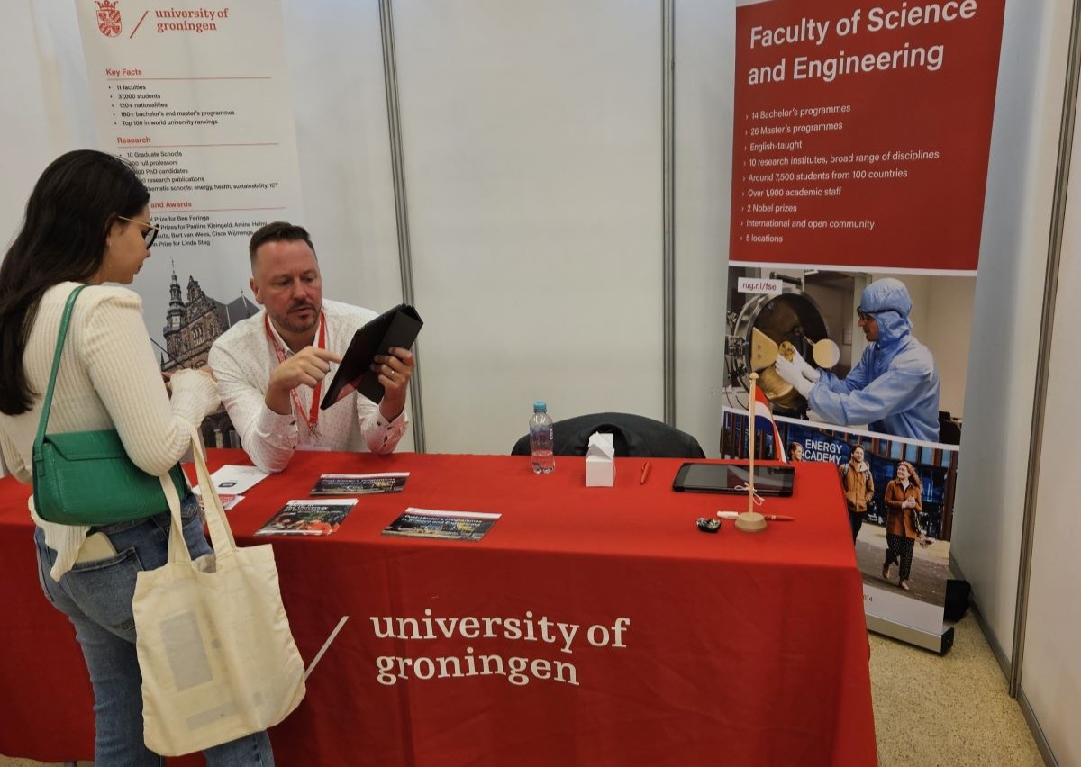 Student with ambassador at information fair