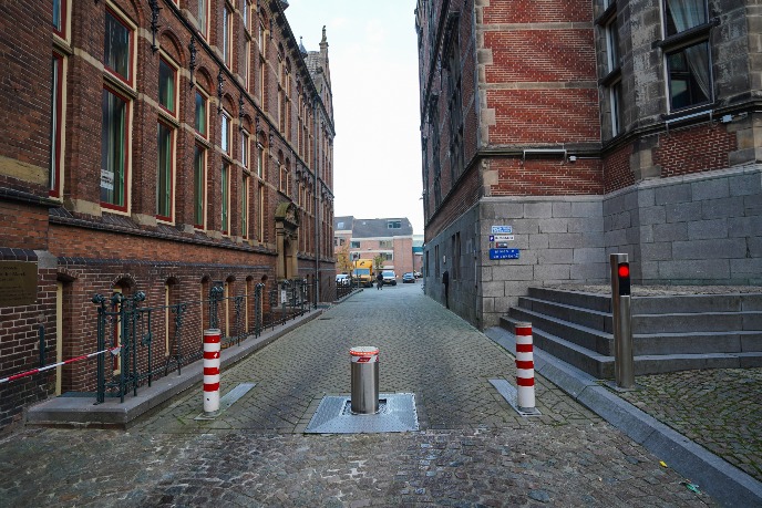 Bollards on the left side of the building, these will take you towards the alternative entrance