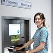 student returning a book at the return machine