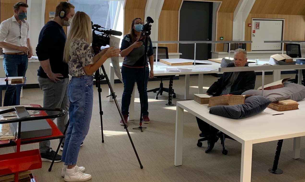 De filmploeg in de onderzoekszaal Bijzondere Collecties; geheel links Frank HarbersThe film crew in the research room; Frank Harbers at the far left