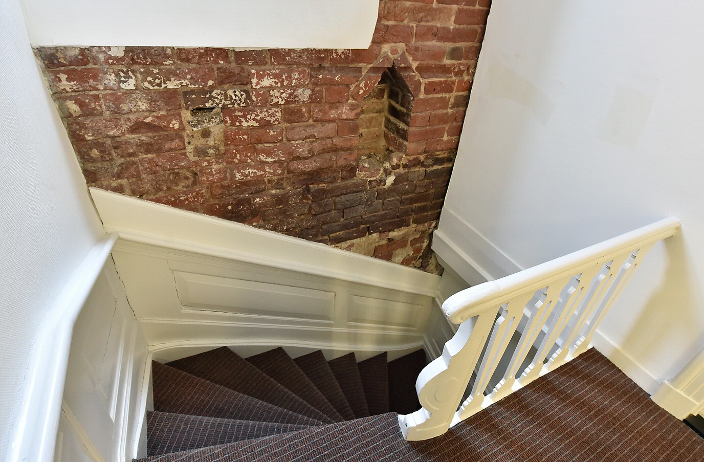 Detail in the staircase in the Philosophy building. The old wall is made of Dutch medieval bricks known as ‘kloostermoppen’ and contains a niche for candles. This building is one of the oldest stone buildings in the city.