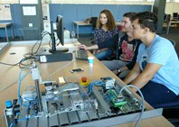 IEM students working with the setup of Festo.