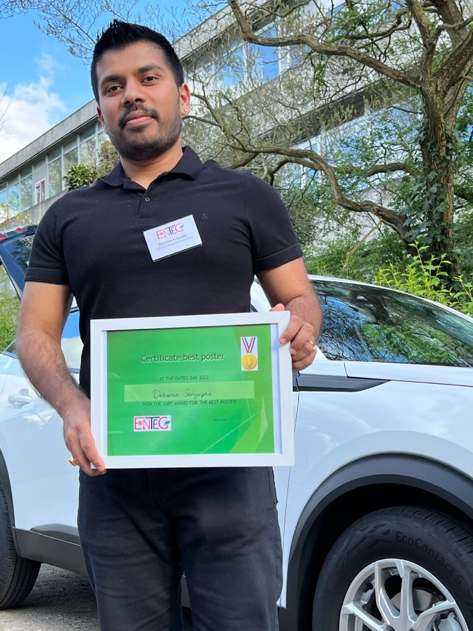 Debarun Sengupta holding the Certificate for best poster award
