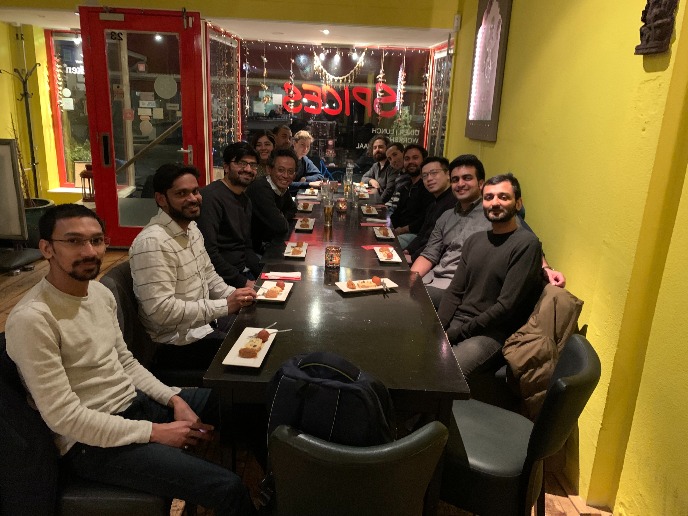 Group dinner with 13 people dining at a long table