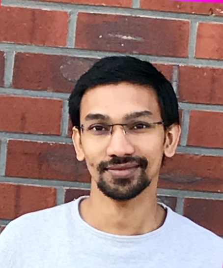 Ishu Aggarwal profile picture, young man with dark short hair wearing glasses and smiling