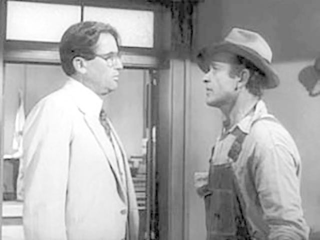 Atticus Finch (Gregory Peck) confronted by Bob Ewell (James Anderson), the father of the white girl allegedly raped by a black man, in a scene from ‘To Kill a Mockingbird’ (1962)