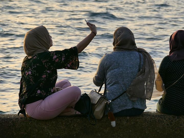 Women in hijab taking selfies and enjoying the view