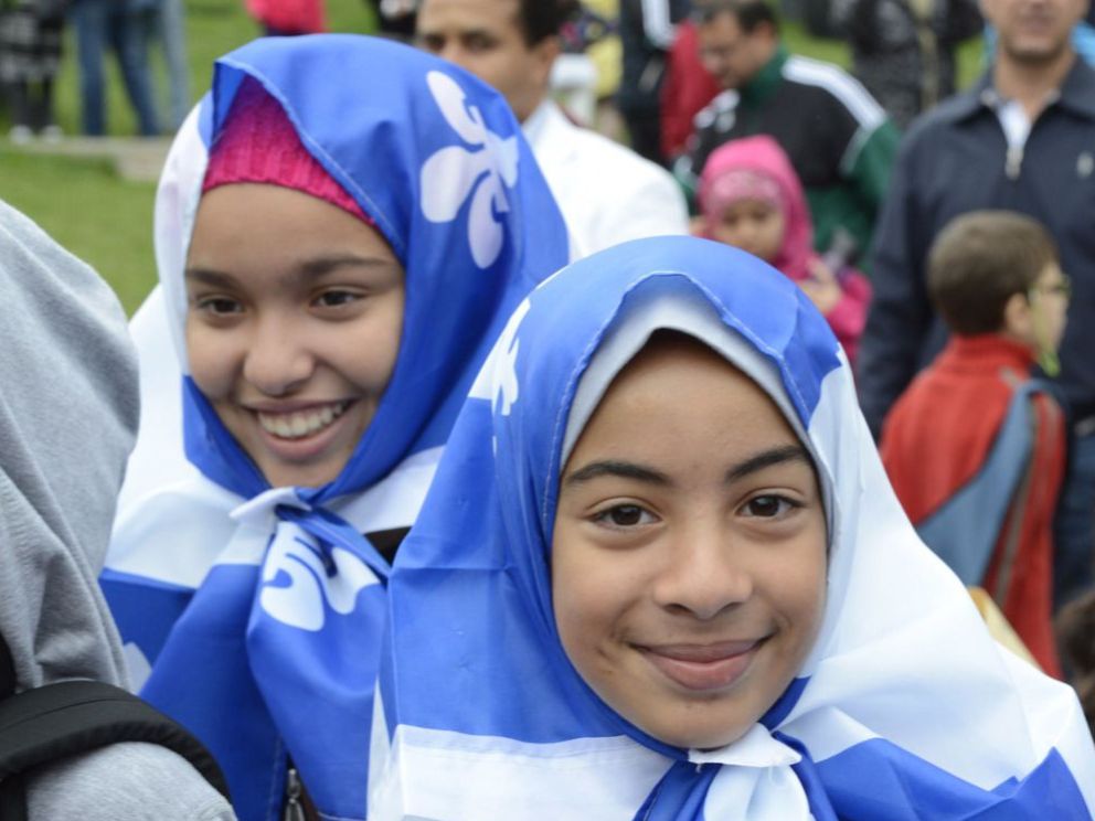 Young women wearing the fleur de lys, a symbol of Quebec. THE CANADIAN PRESS/Ryan Remiorz.