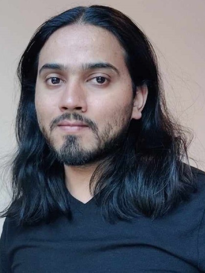 a profile picture of Kismat Pandey with long dark hair, moustache and beard, wearing a black T-shirt