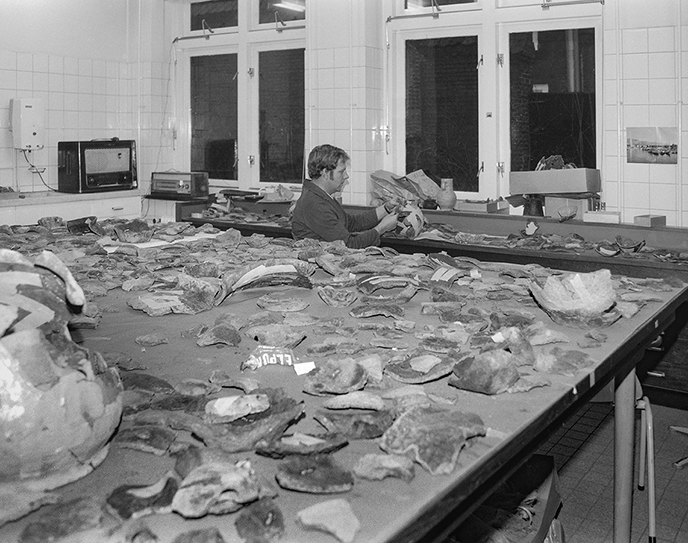 Sticking together potsherds.