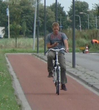 Typical Dutch? Texting while cycling...