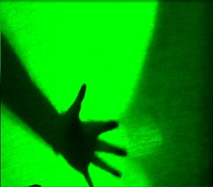 Flyer with image of a silhouetted hand in bright green light.