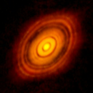 ALMA is thought to observe planet formation directly around this young star called HL Tau. The concentric rings around the star suggest that planets have swept their orbits clean of dust. Image credit: ALMA, C. Brogan and B. Saxton.