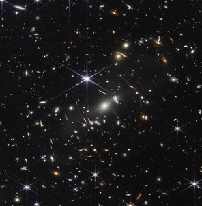Thousands of galaxies flood this near-infrared image of galaxy cluster SMACS 0723. High-resolution imaging from the James Webb Space Telescope combined with a natural effect known as gravitational lensing made this finely detailed image possible. Image credit: NASA/ESA/CSA/STScI