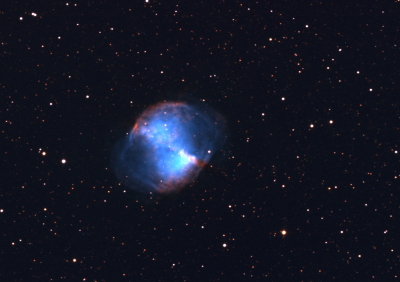 Shot of the planetary nebulea, Messier 27 (M27) also known as the Dumbbell nebula. This colour image was made by combining the light of oxygen (blue-green) and hydrogen (red). A planetary nebula arises when a bright star (like the Sun) emits its outer layers at the end of its lifetime.