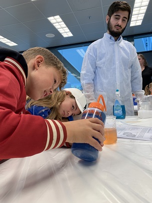 Image of two children who are performing a small lab experiment.