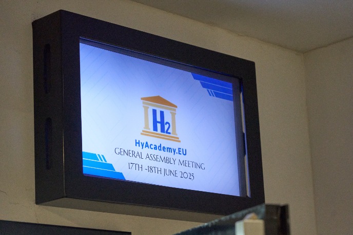 The logo of HyAcademy at the entrance of the meeting room